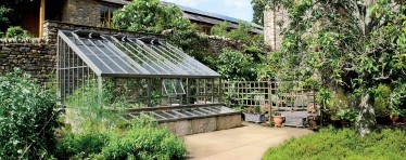 Bespoke Hartley Botanic Lean-To Greenhouse in a Garden