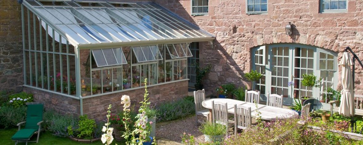 Hartley Botanic Architectural Range Glasshouse in a Garden.