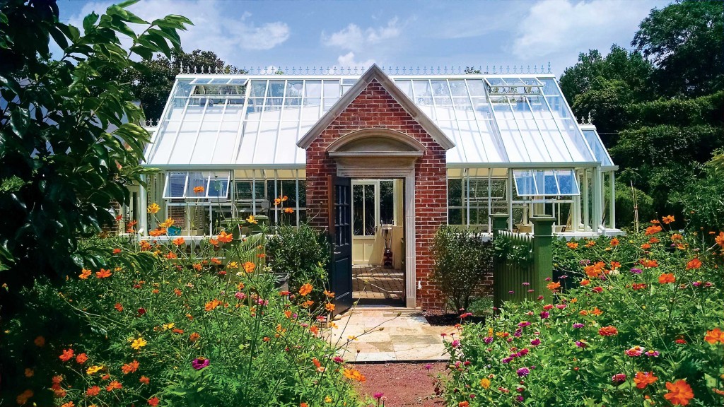 A bespoke Hartley Botanic glasshouse with a brick front entrance