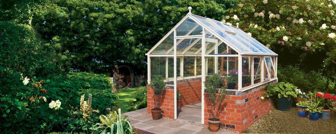 Close Up of a White Hartley Botanic 8x8 Tradition 8 Greenhouse With Brick Base.